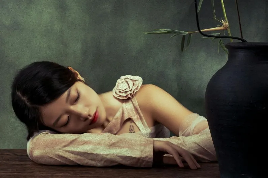 woman laying on her arms against dark green backdrop